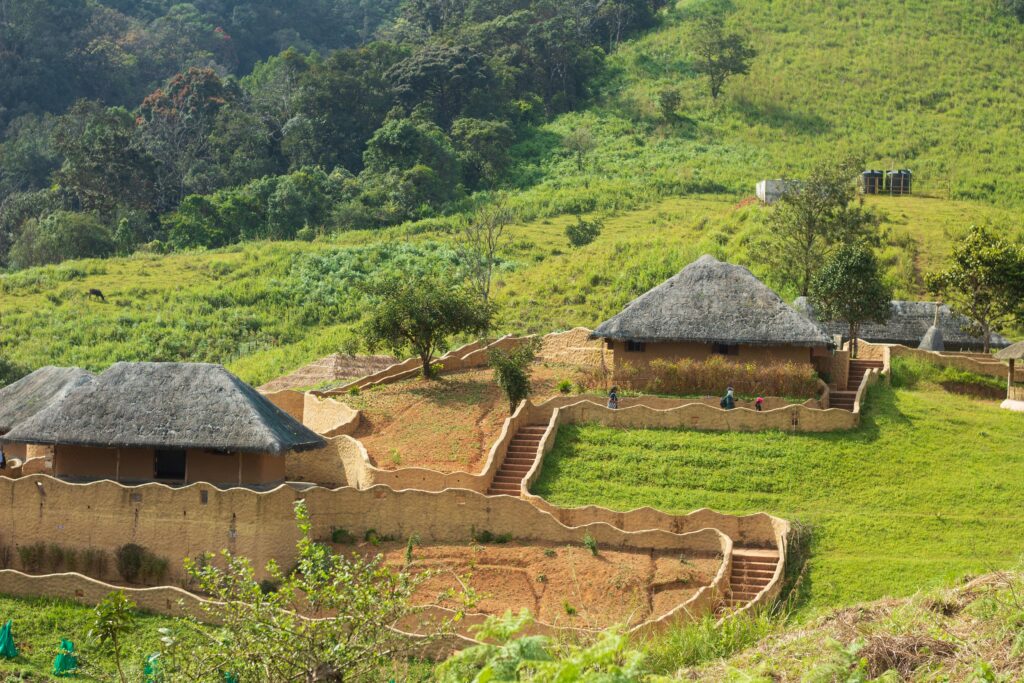 Explore the serene rural architecture of Wayanad, India, amidst lush green hills.